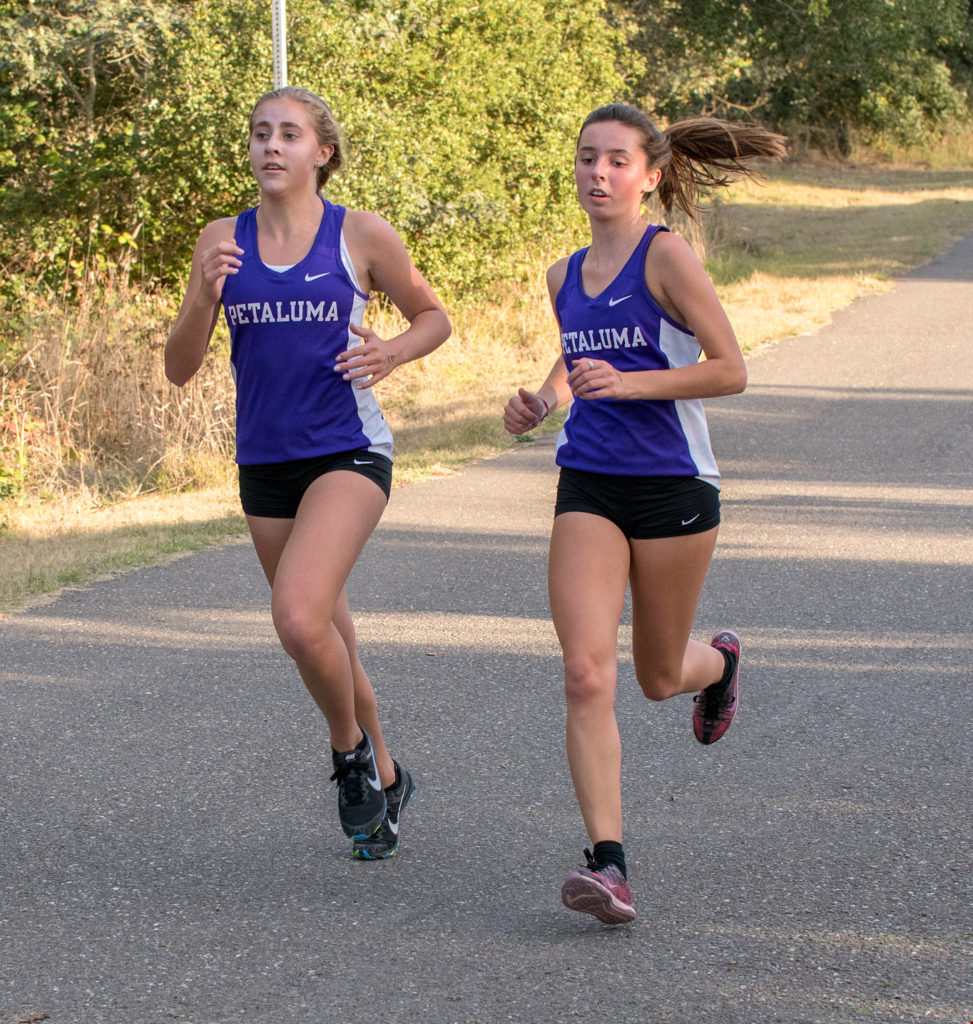 Finishing 1&2, Petaluma’s Camille Flynn (L) in18:07 and Teammate Sophie Hospodar in 18:08