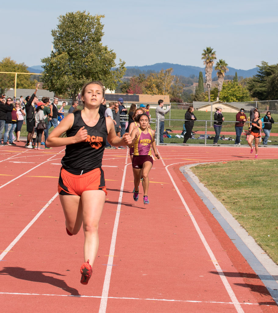 10th place and final medal winner was Iona Mahony-Moyer of Arcata in 22:43. in the background ready to finish in 11th, 12th  places for Pinaer were Fatima Olivares in 22:46.01 and Veronica Rodriguez in 22:46.88 and just behind theme see Arcata’s Elizabeth Uemura who will finish in 22:52