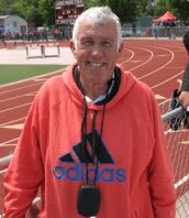 Smiling older man in orange Adidas hoodie