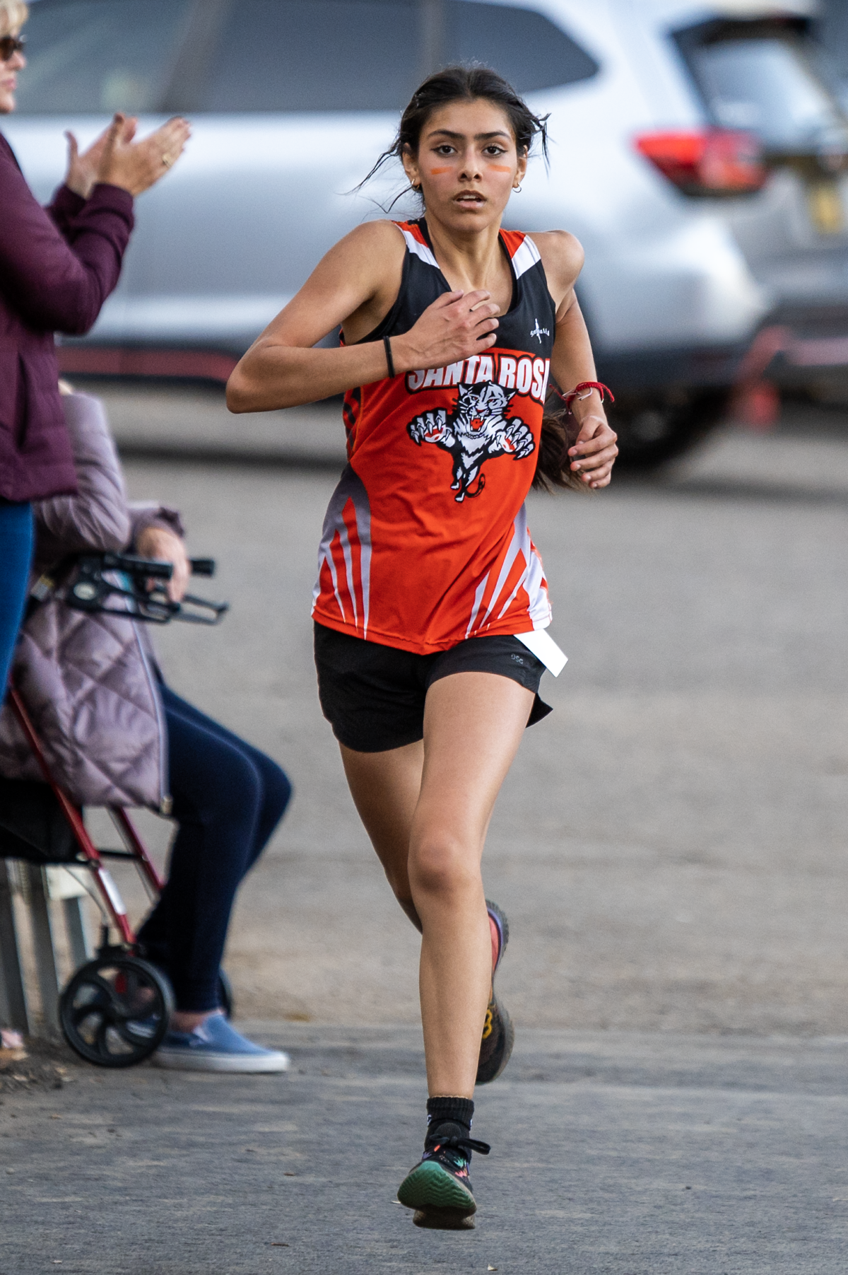 Female cross-country runner in red singlet