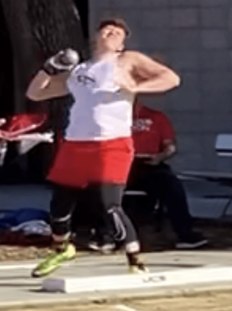 Shot put athlete mid-throw