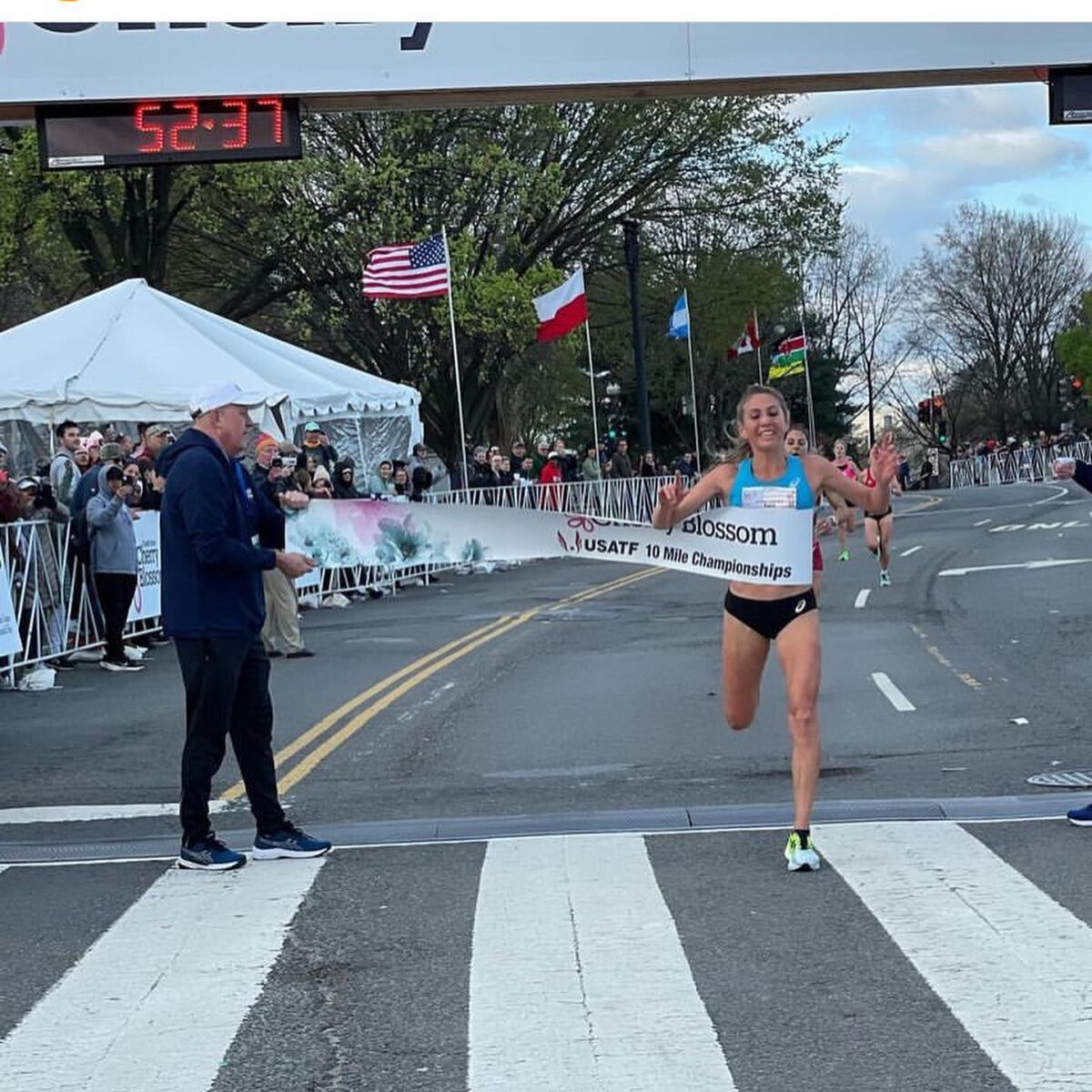 Runner crossing finish line at 10-mile race