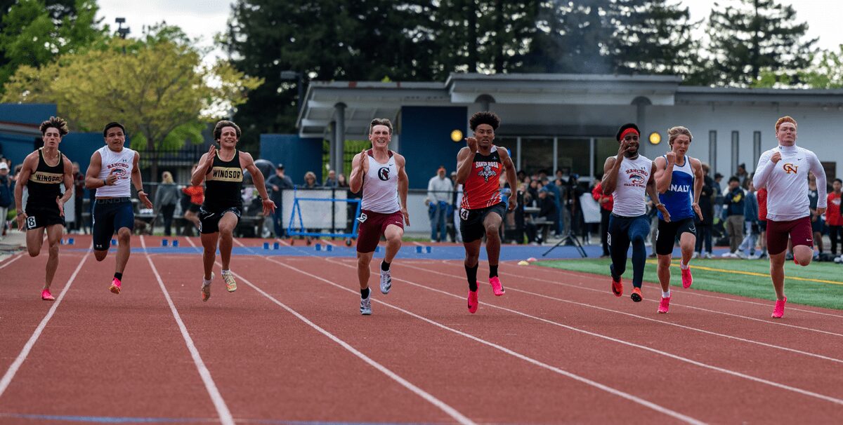 Athletes sprinting in outdoor track race
