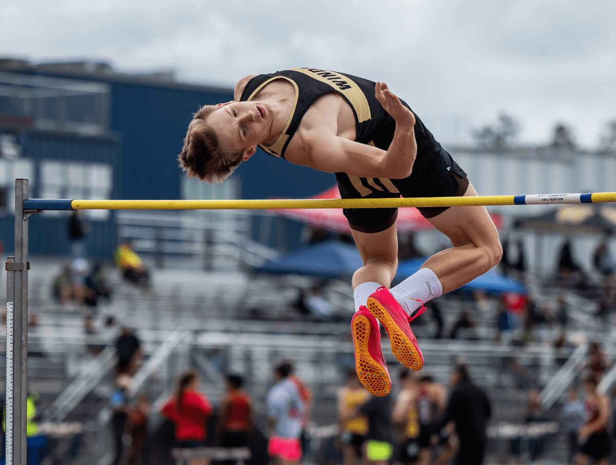 Athlete clearing high jump bar at track meet