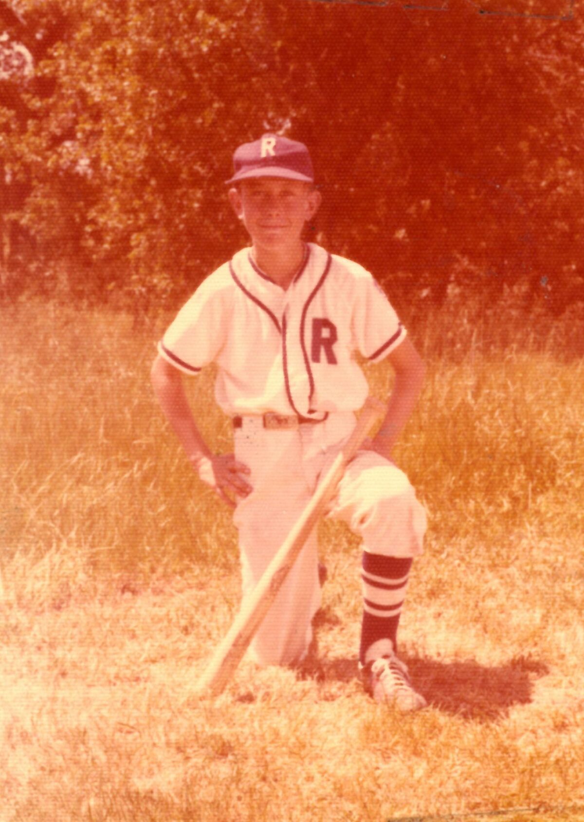 Boy kneeling in vintage baseball uniform