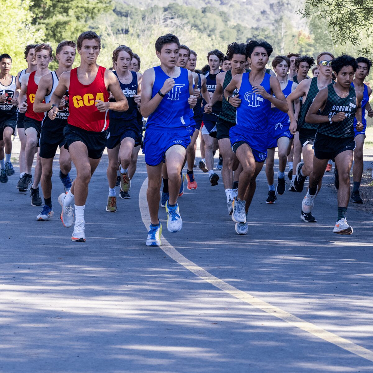 High school cross country runners racing on road