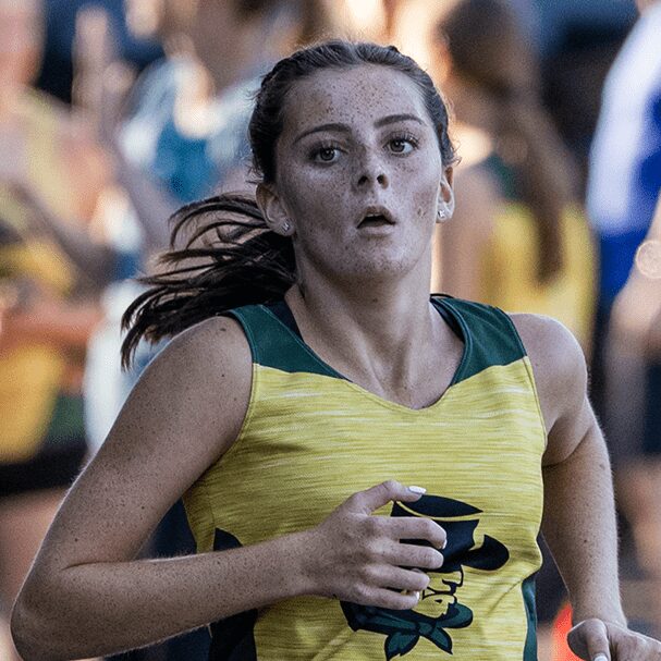 Young female runner in yellow singlet