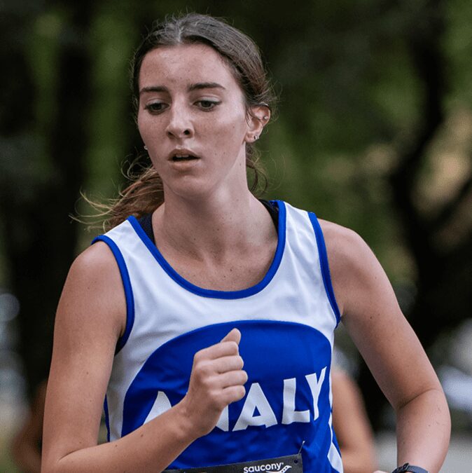 Female cross-country runner in blue singlet