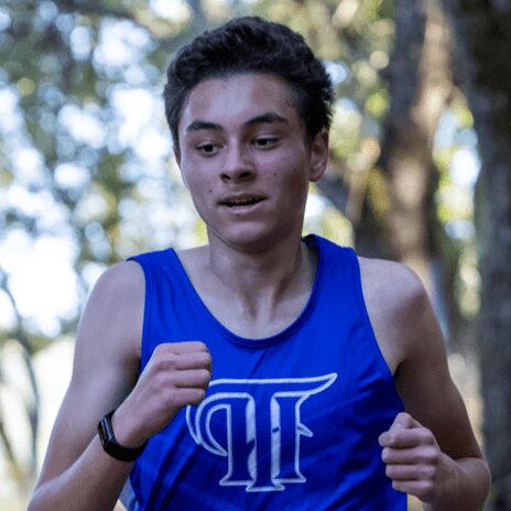 Teen runner in blue singlet outdoors