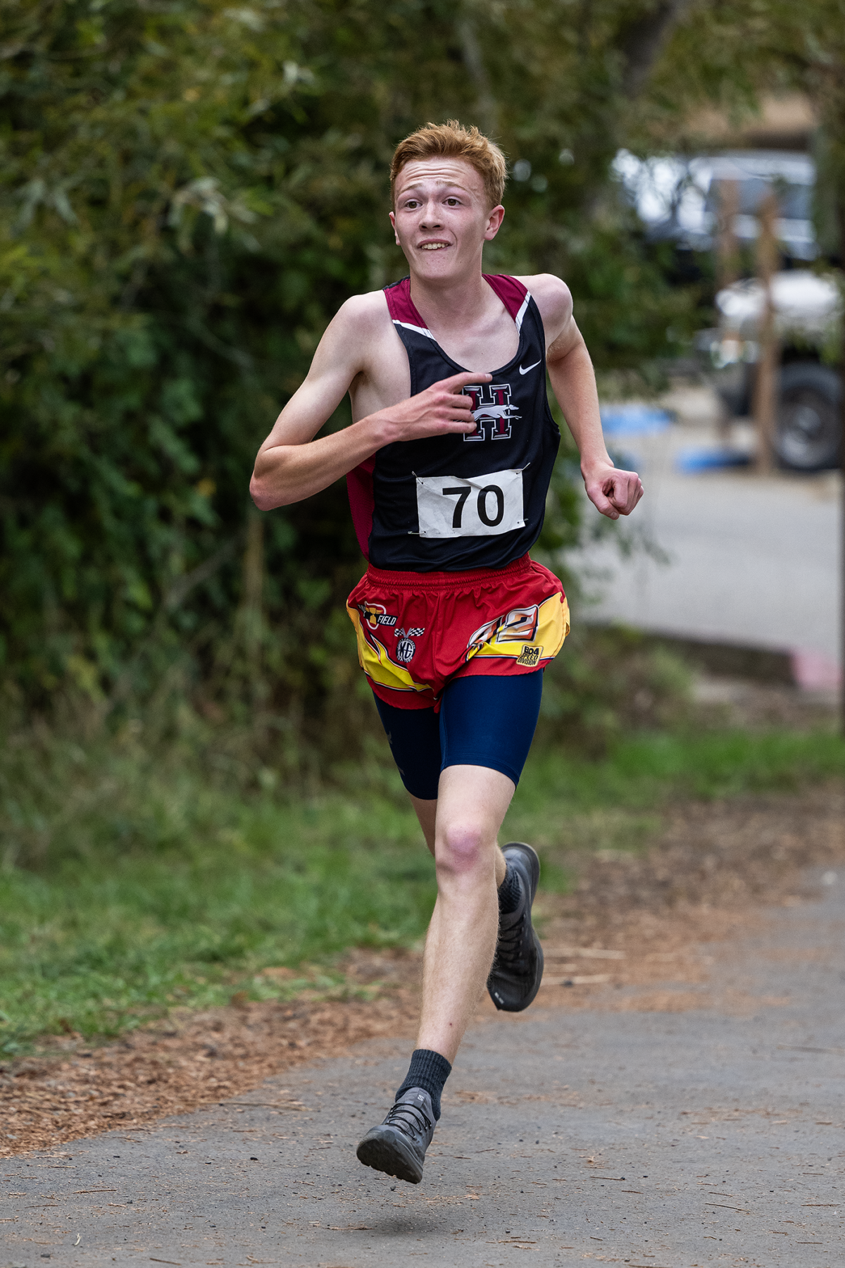 Young male cross-country runner wearing bib 70