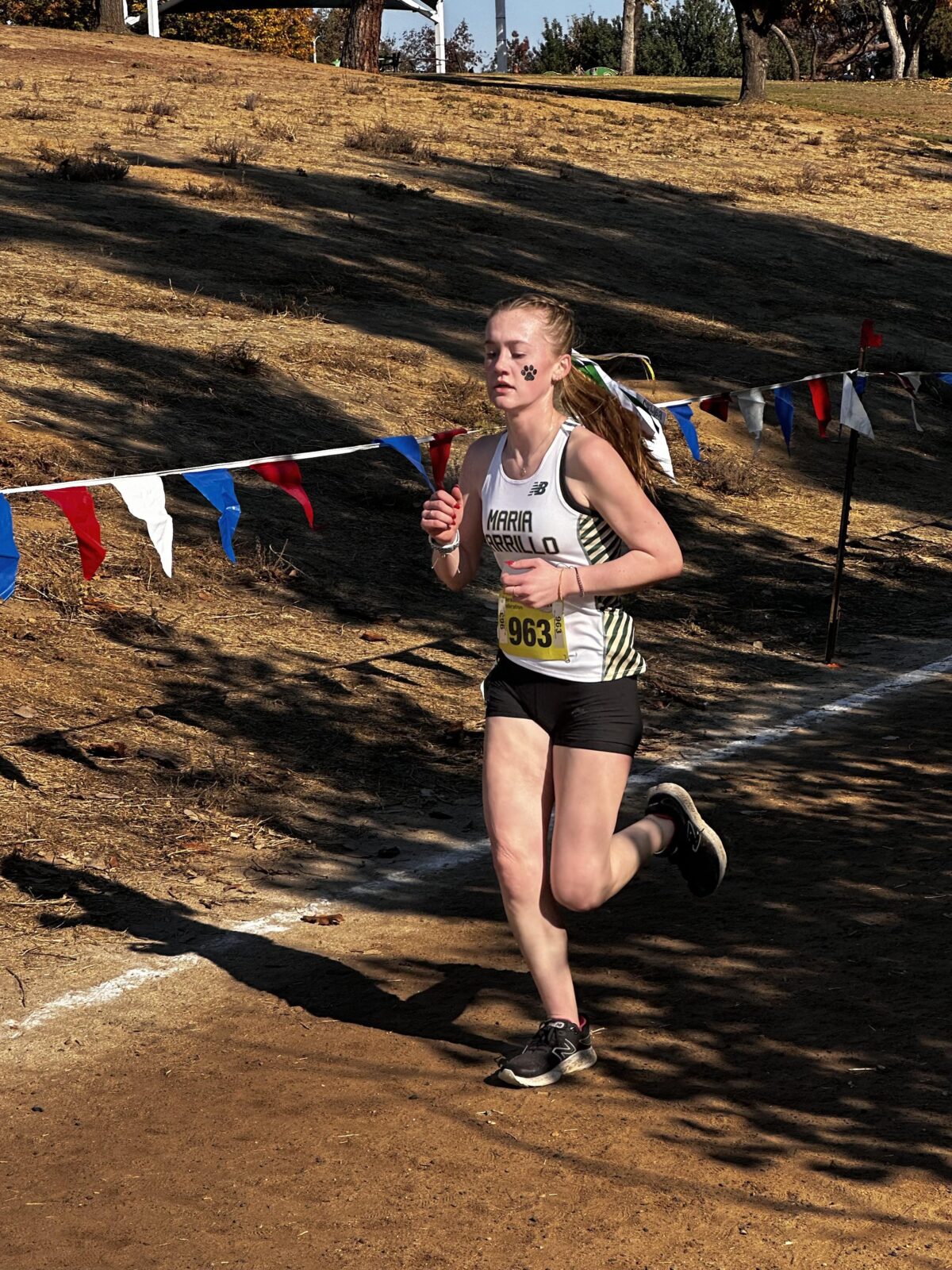 Female cross-country runner rounding course