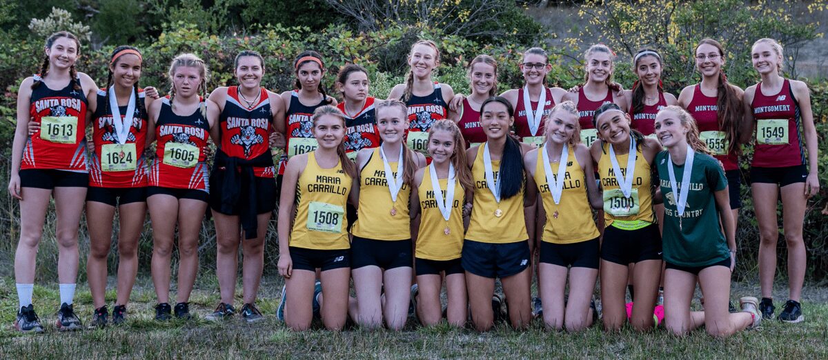 High school cross country teams posing with medals