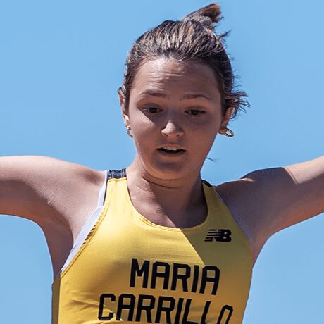 Track athlete mid-jump in yellow uniform