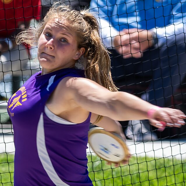 Athlete throwing discus during competition