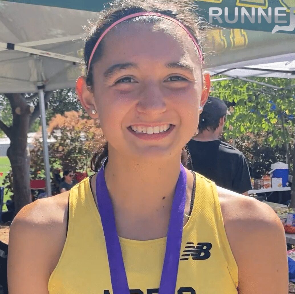 Smiling runner wearing medal at outdoor event