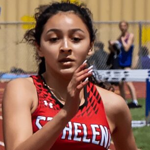 Track athlete sprinting in red uniform