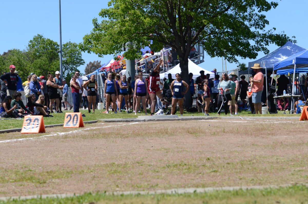 Athletes and spectators at outdoor track meet