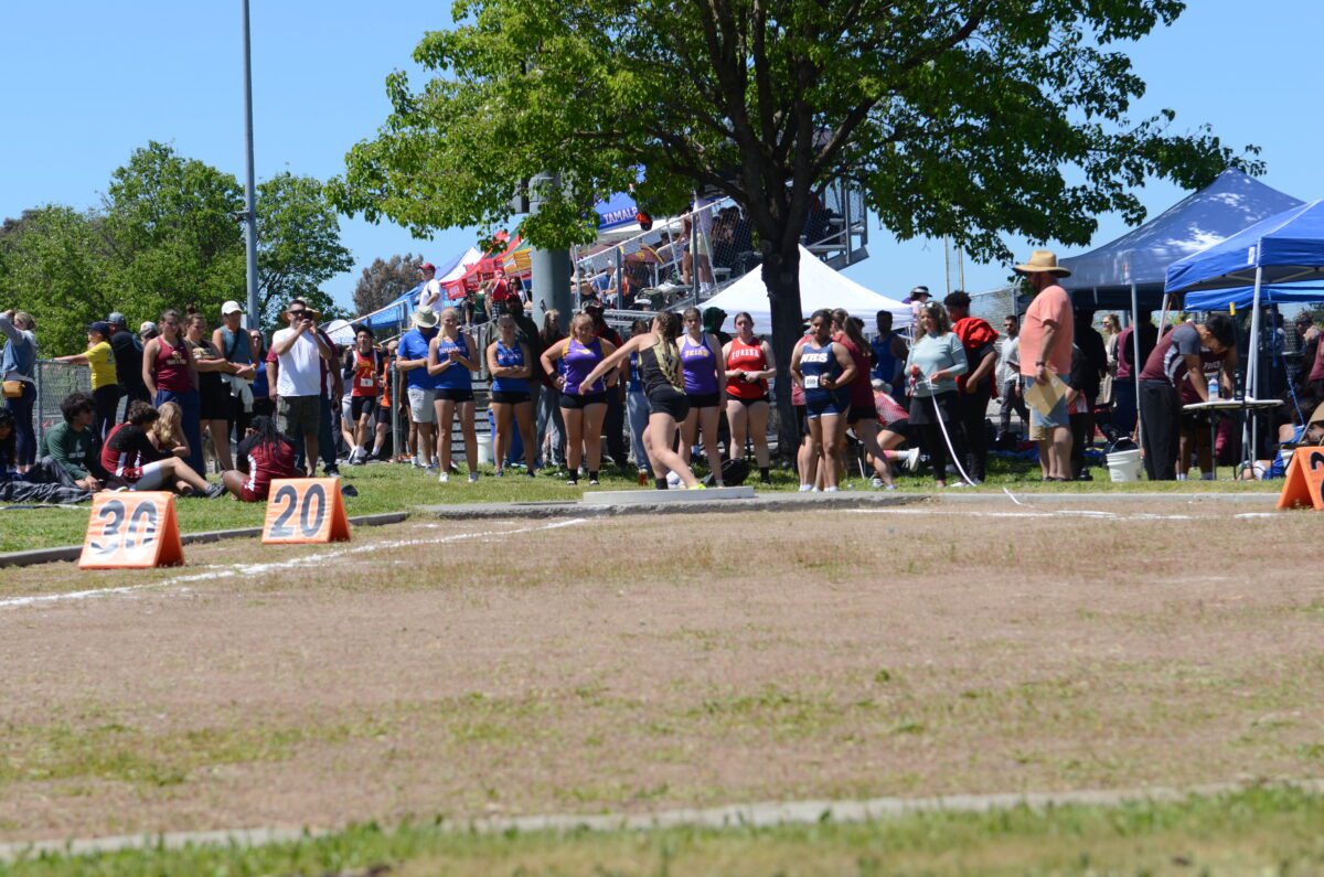 Athletes and spectators at outdoor track meet