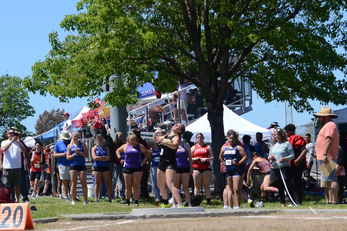 Track athletes at outdoor shot put competition