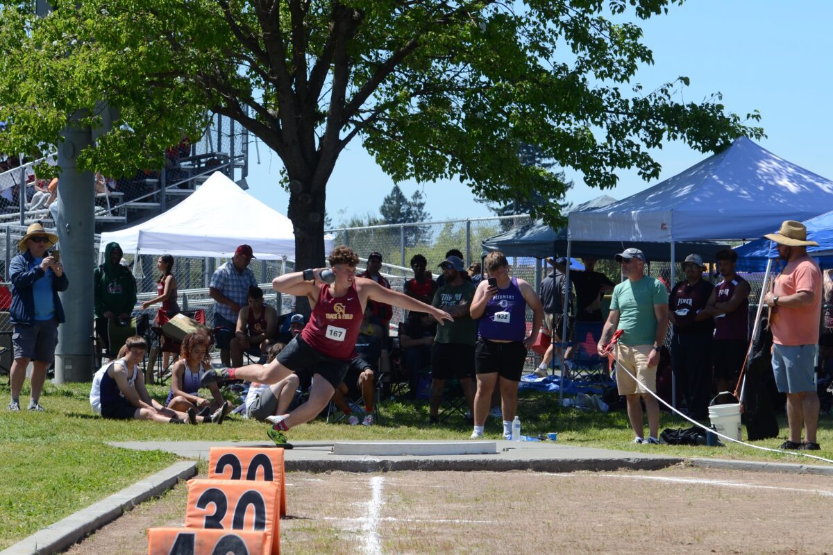 Athlete mid long jump at track meet