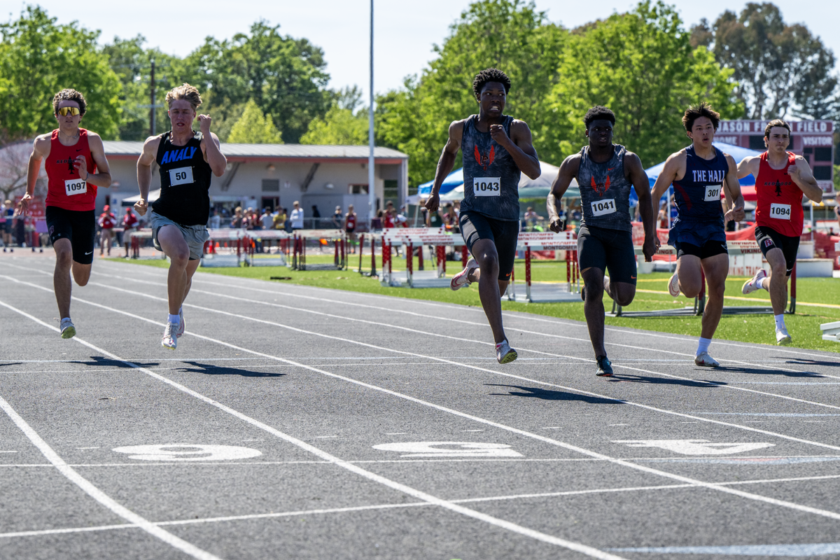 Athletes sprinting in race on outdoor track