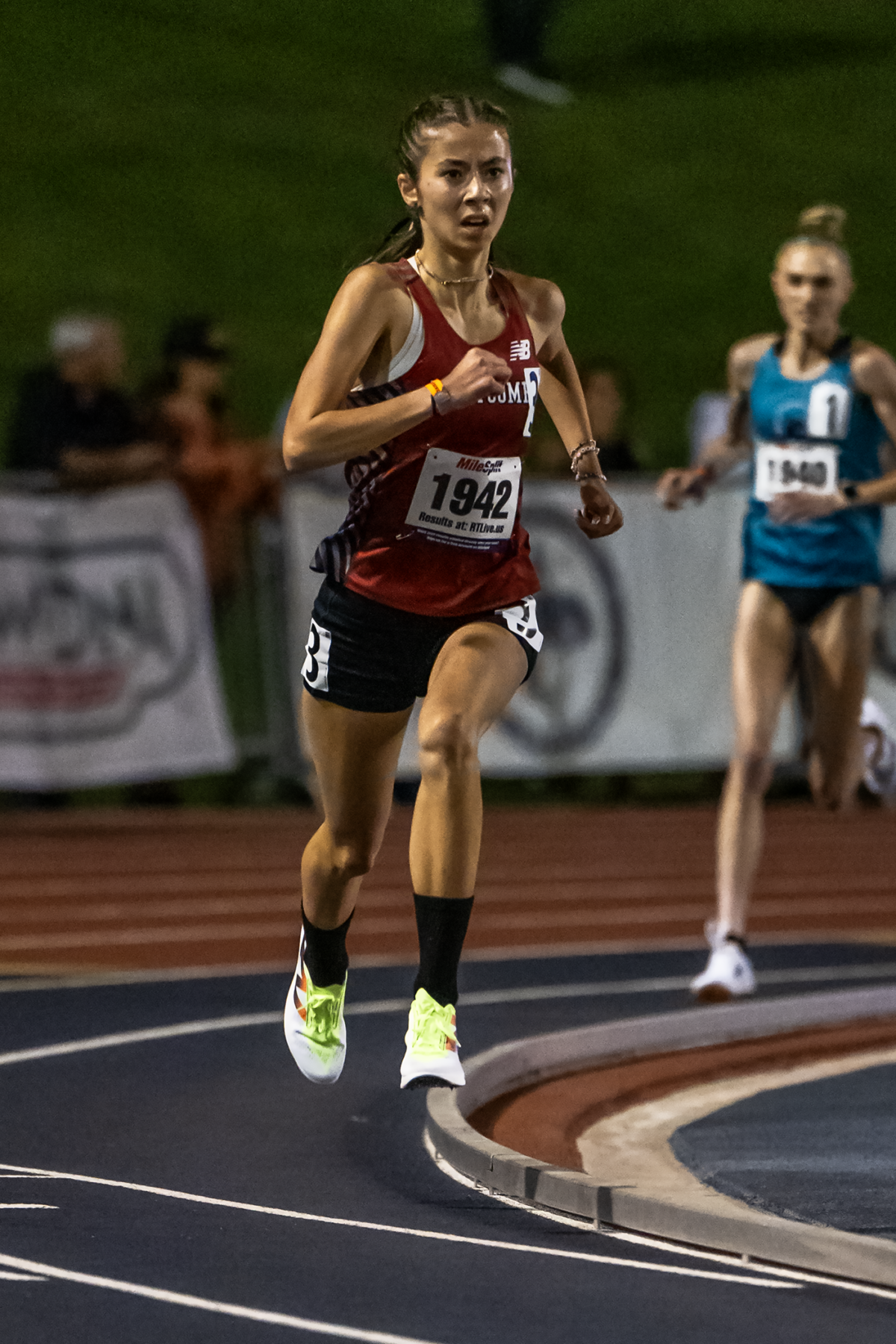 Female athlete sprinting on track curve