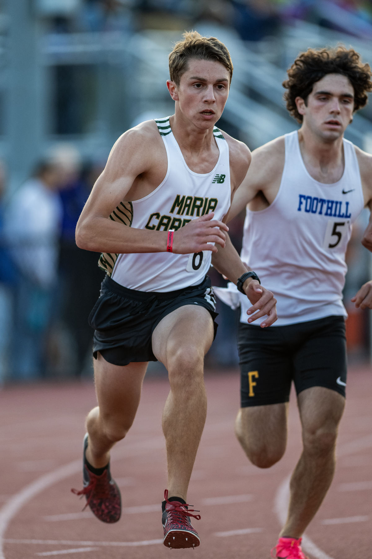 Two runners sprinting on outdoor track