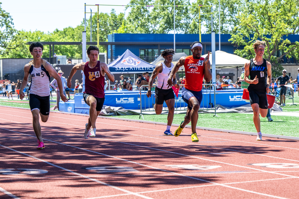 Five sprinters racing on outdoor track