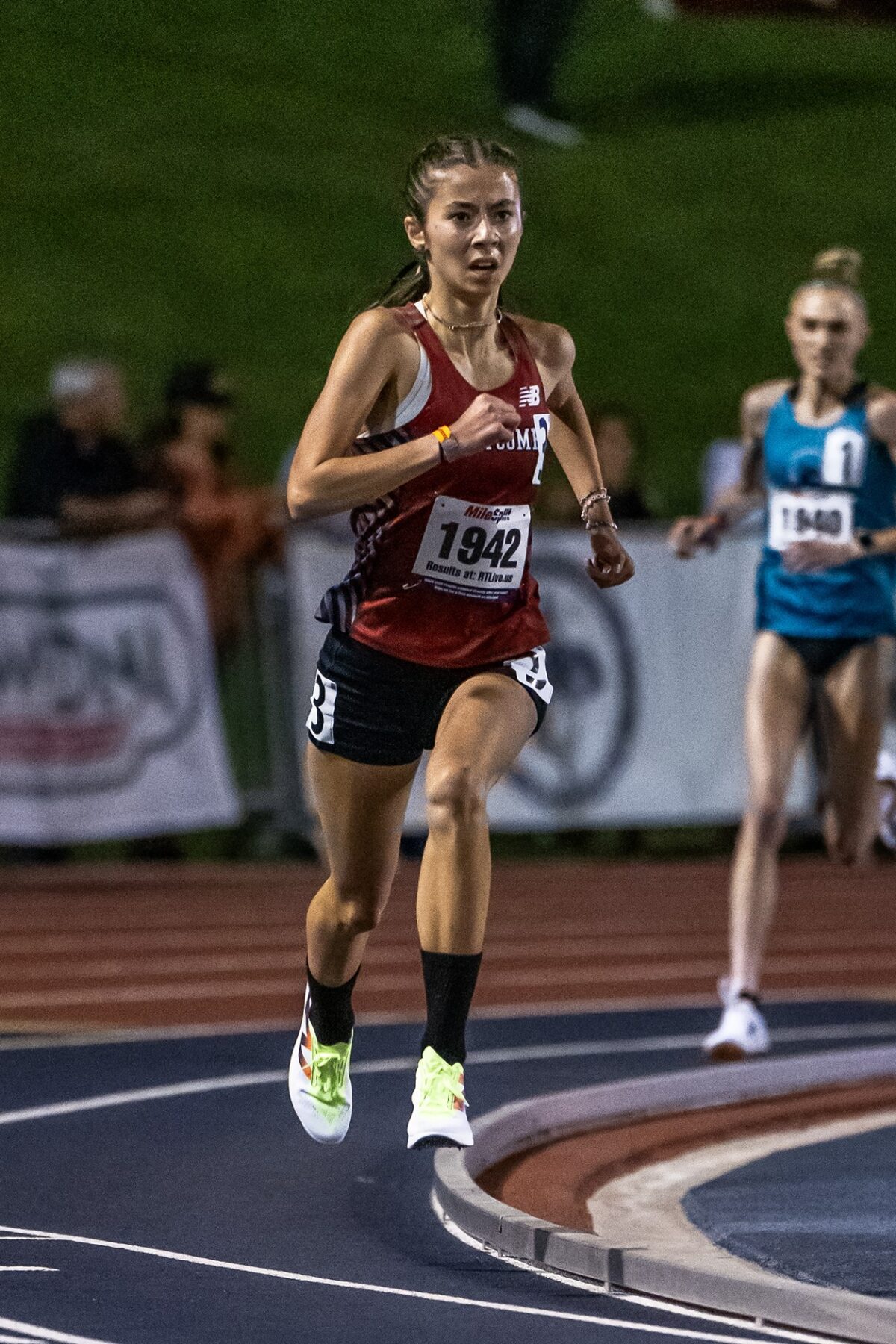 Female athlete sprinting on curved track