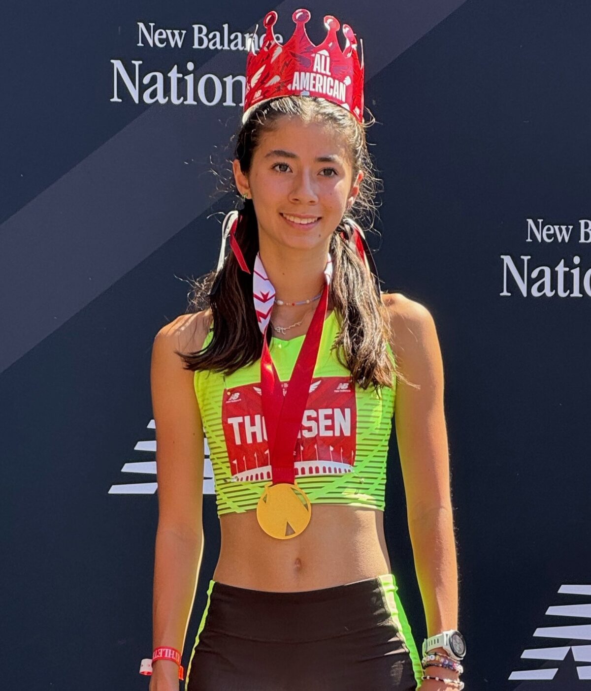 Young athlete wearing crown and gold medal