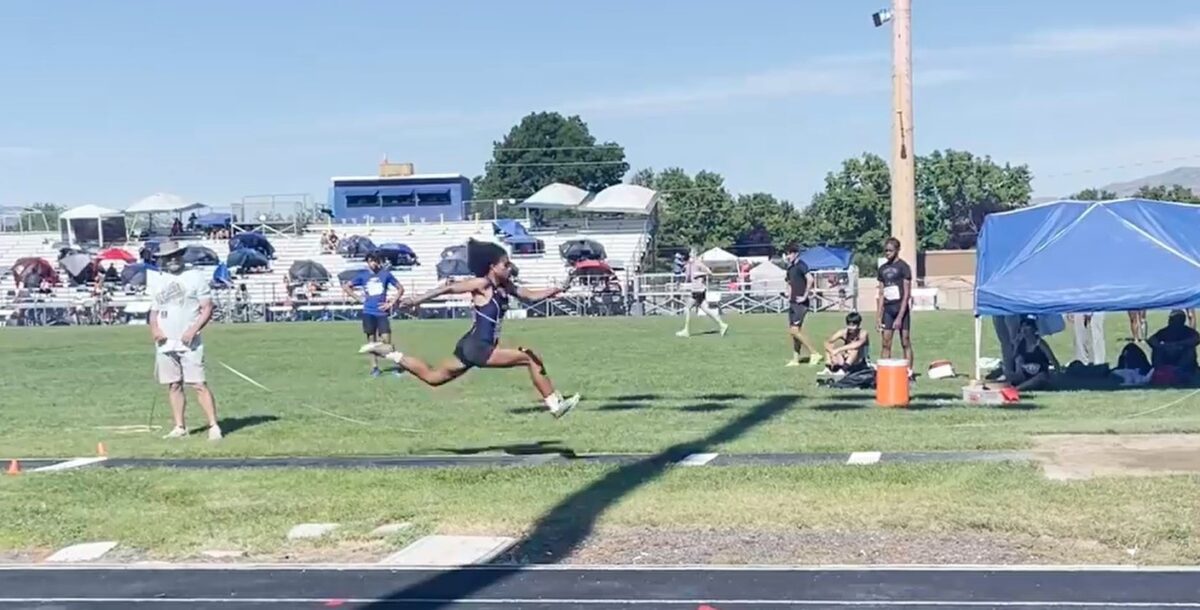 Athlete mid-air during long jump attempt