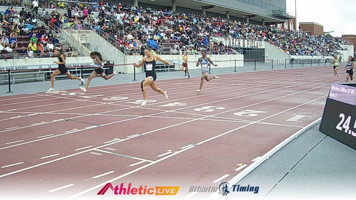 Sprinters racing toward finish line at stadium