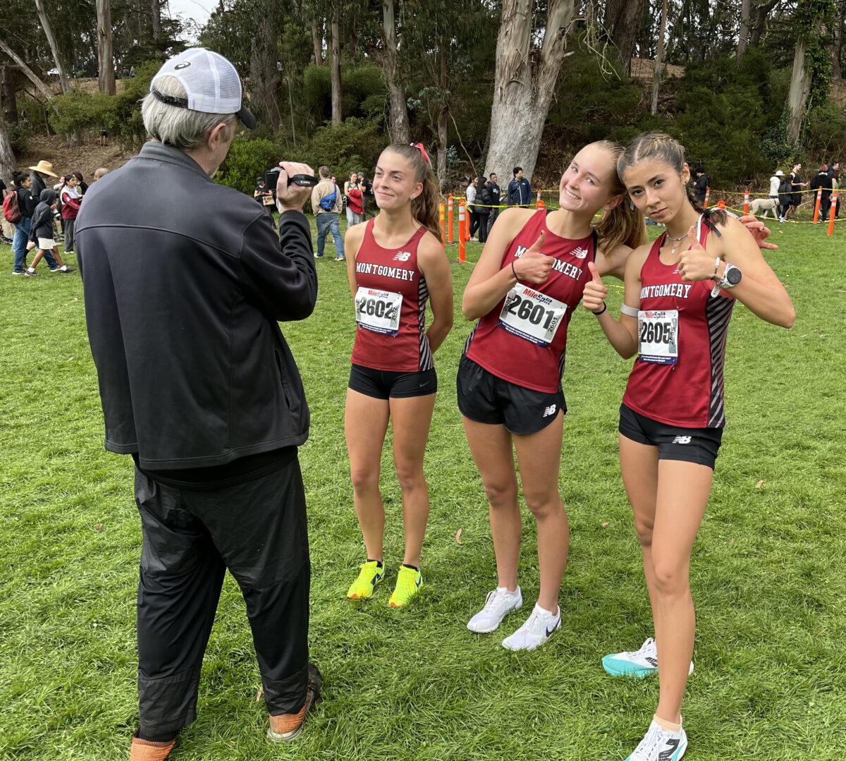 Three cross-country runners posing for photo