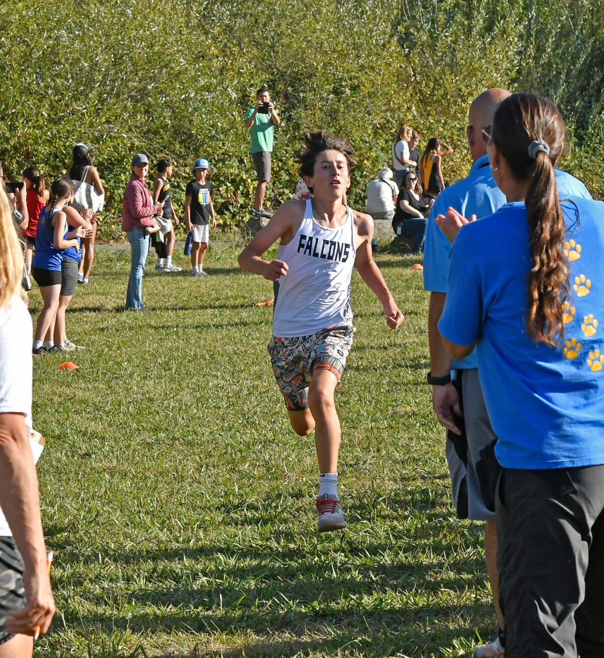 Cross-country runner in Falcons jersey sprinting