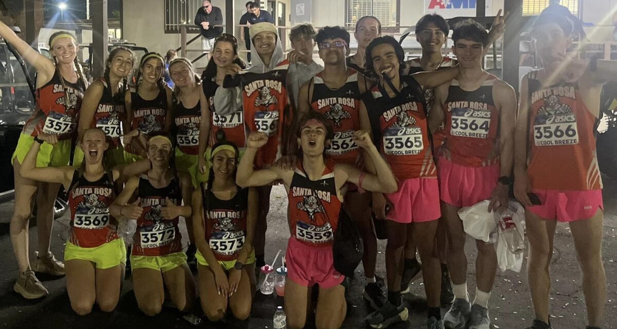Group of runners posing at nighttime race