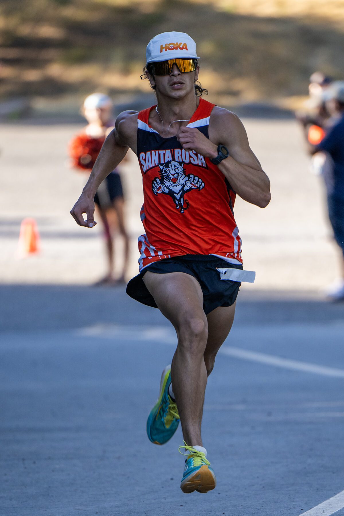 Athlete sprinting in red Santa Rosa singlet
