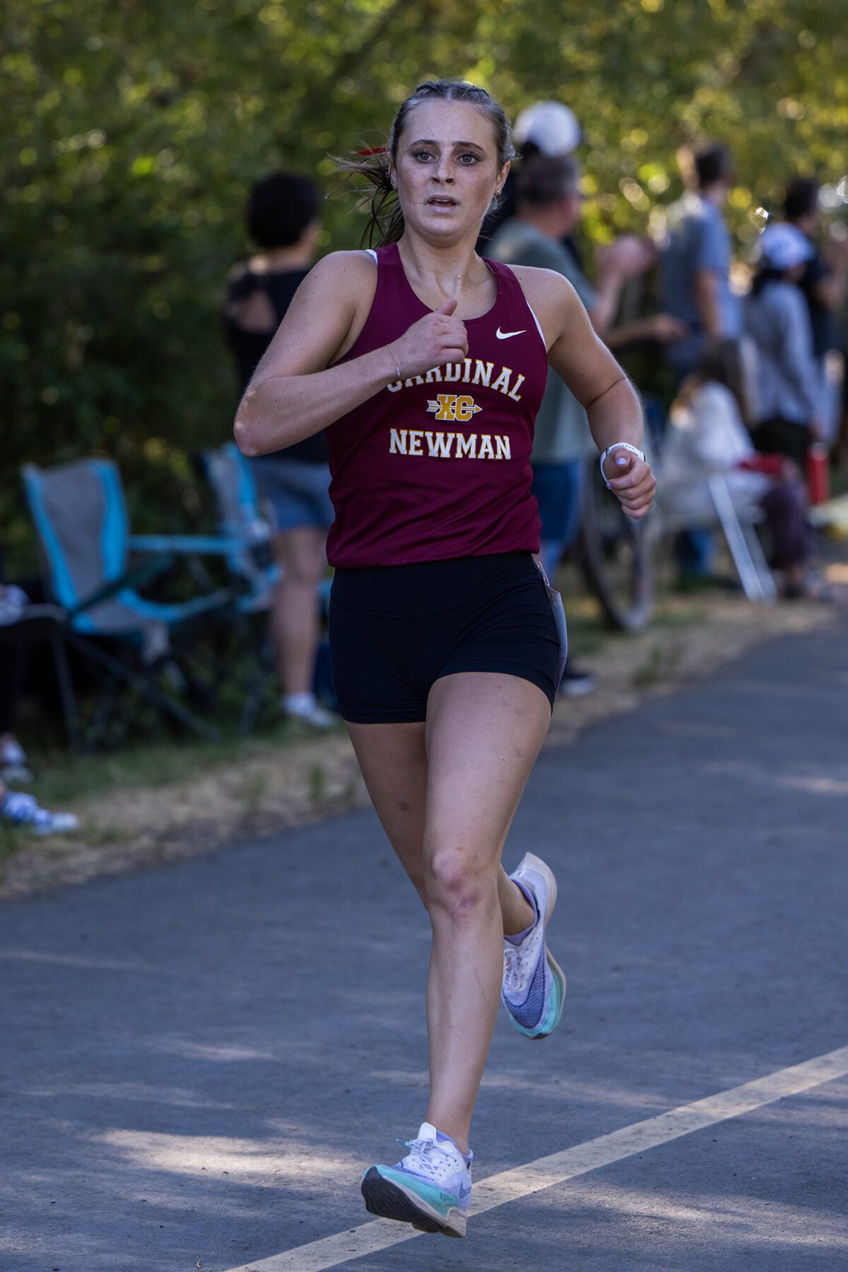 Female runner in Cardinal Newman maroon singlet
