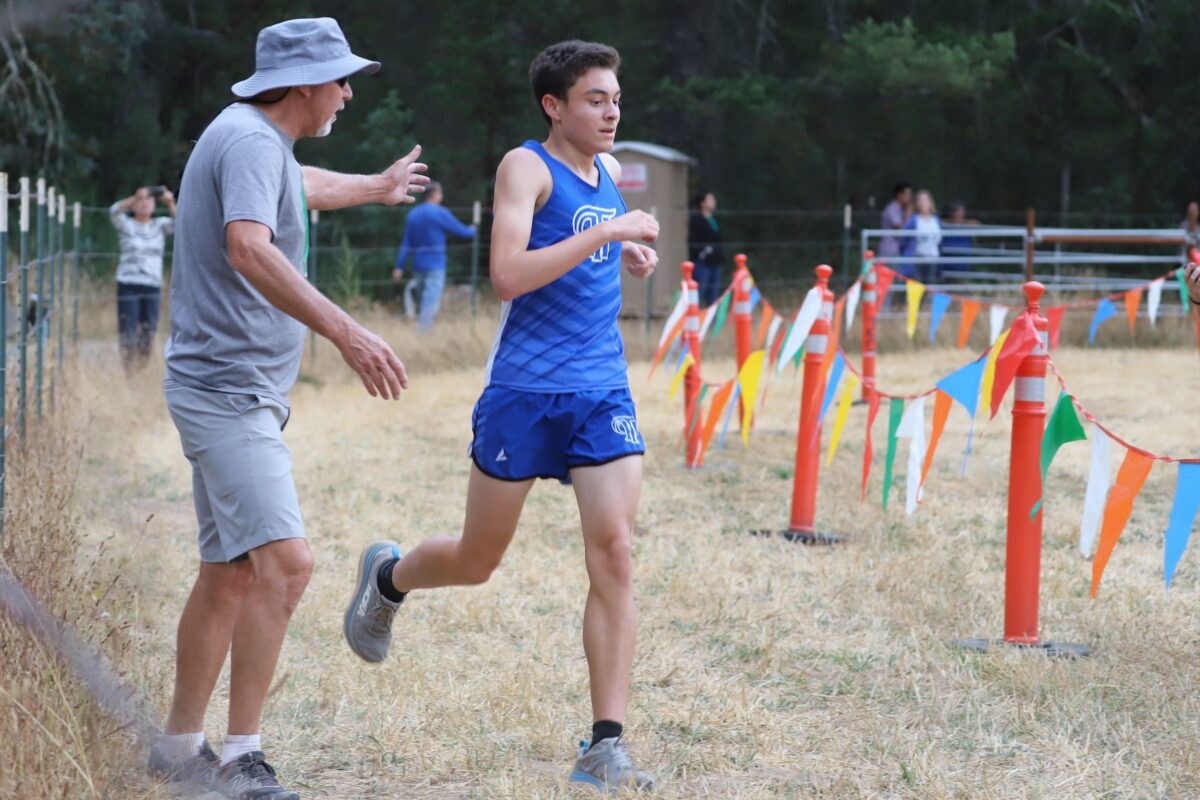 Runner in blue singlet near coach