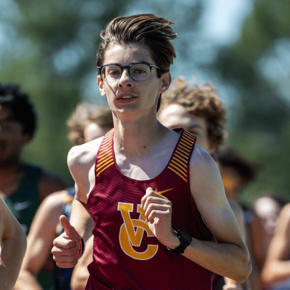 Teen runner in maroon singlet and glasses