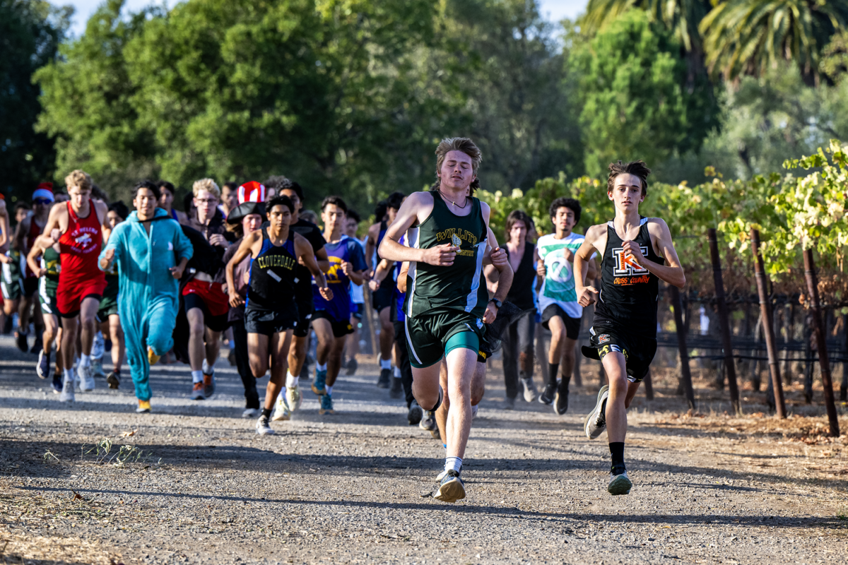 High school cross-country runners racing on trail