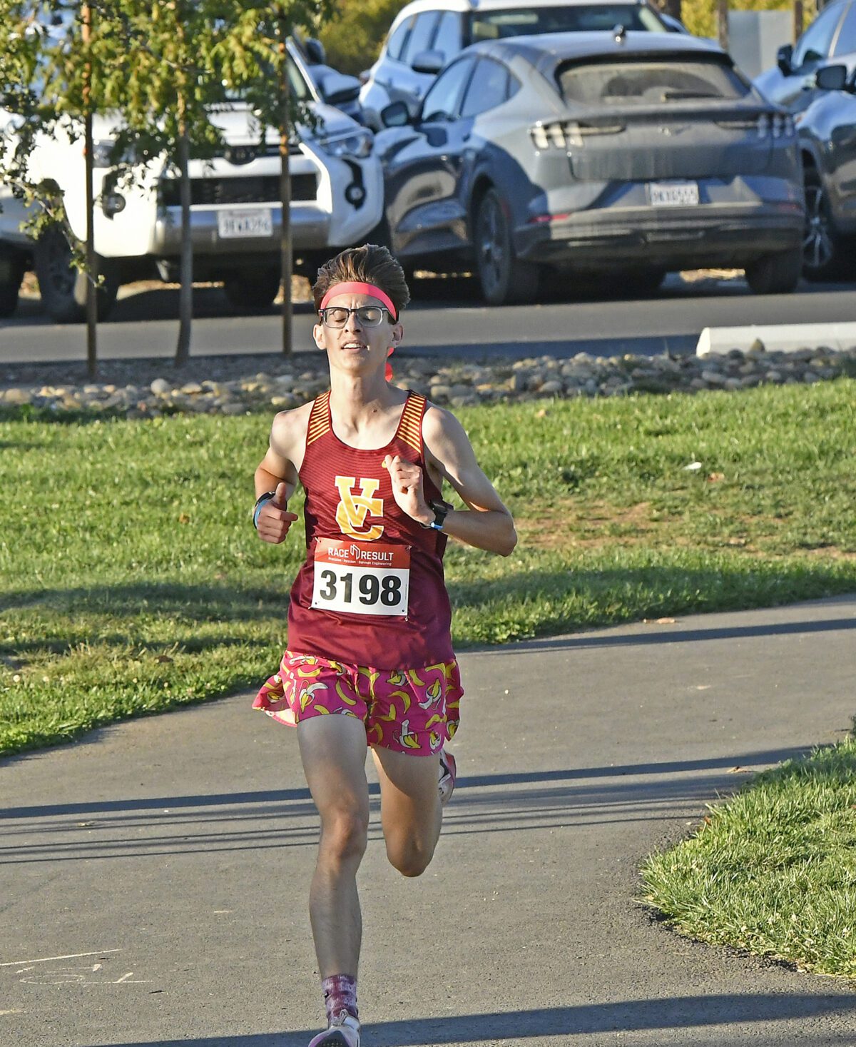 Runner with bib 3198 racing on paved path
