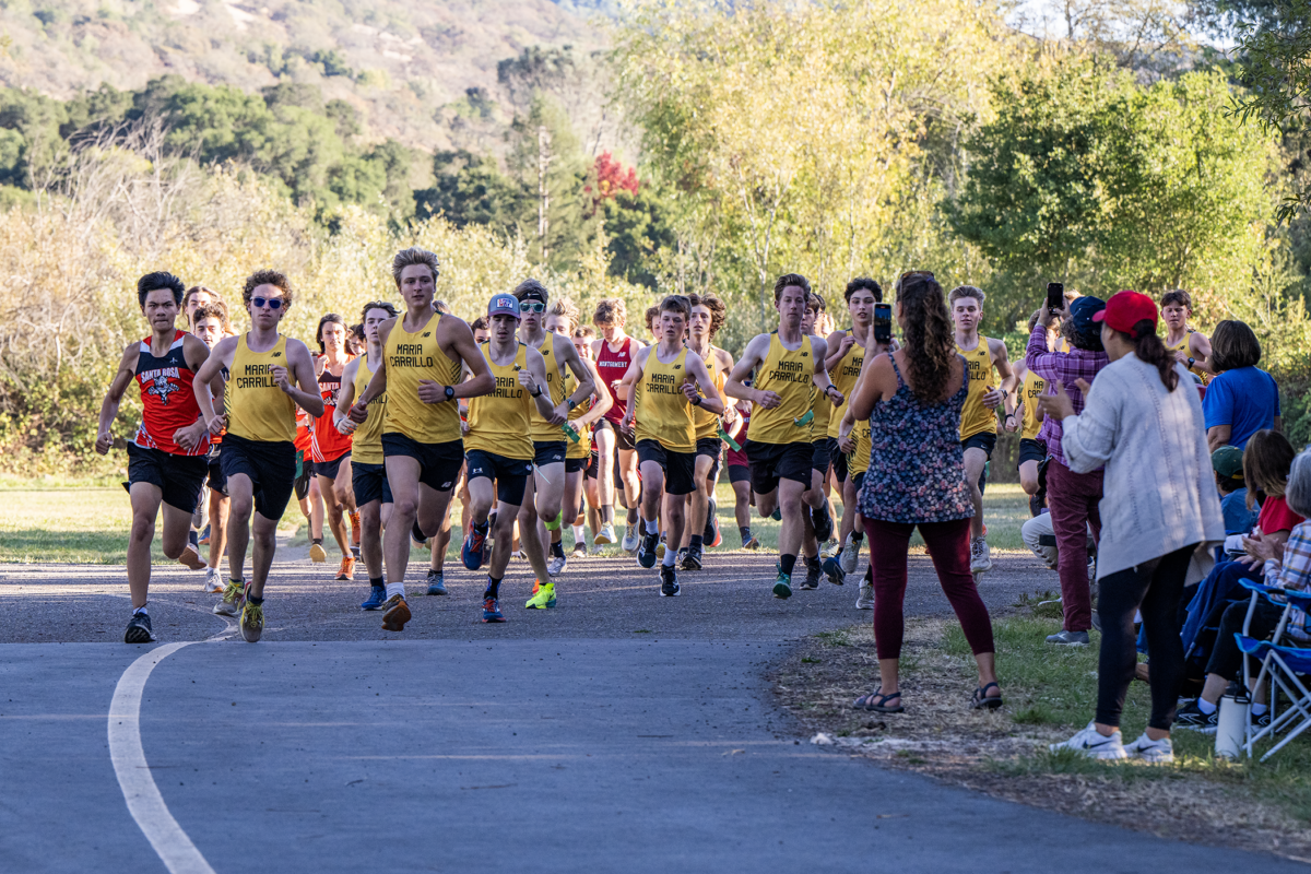 High school cross-country runners racing on trail
