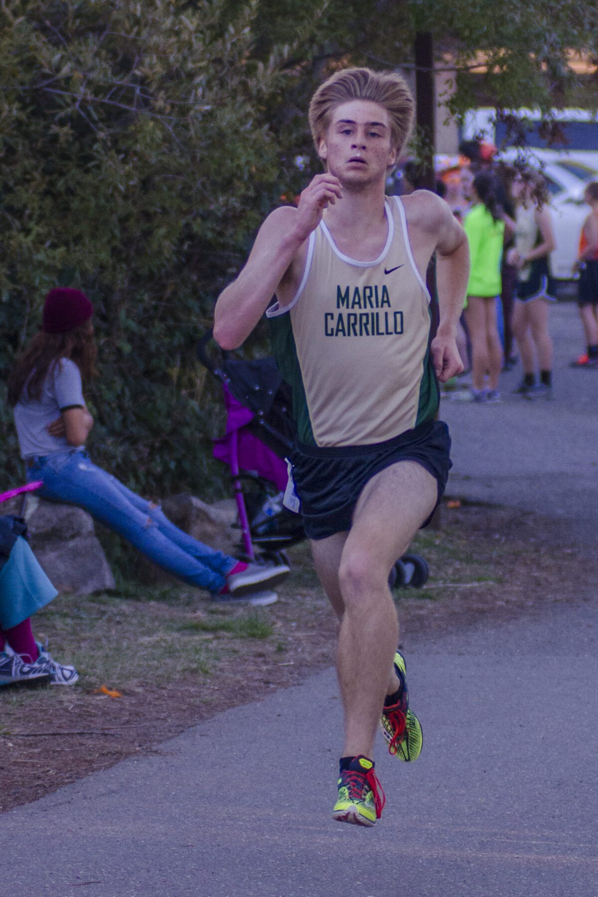 young cross country runner sprinting on path