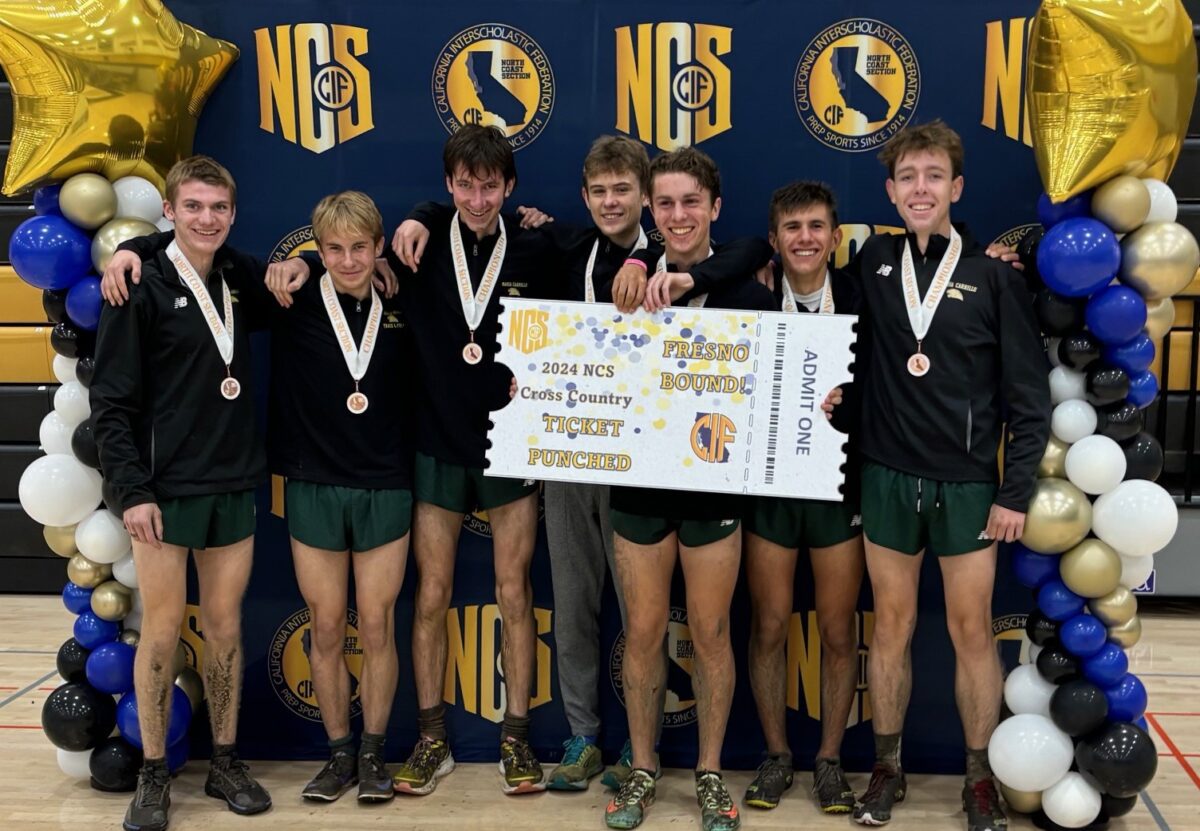 High school cross country team holding ticket