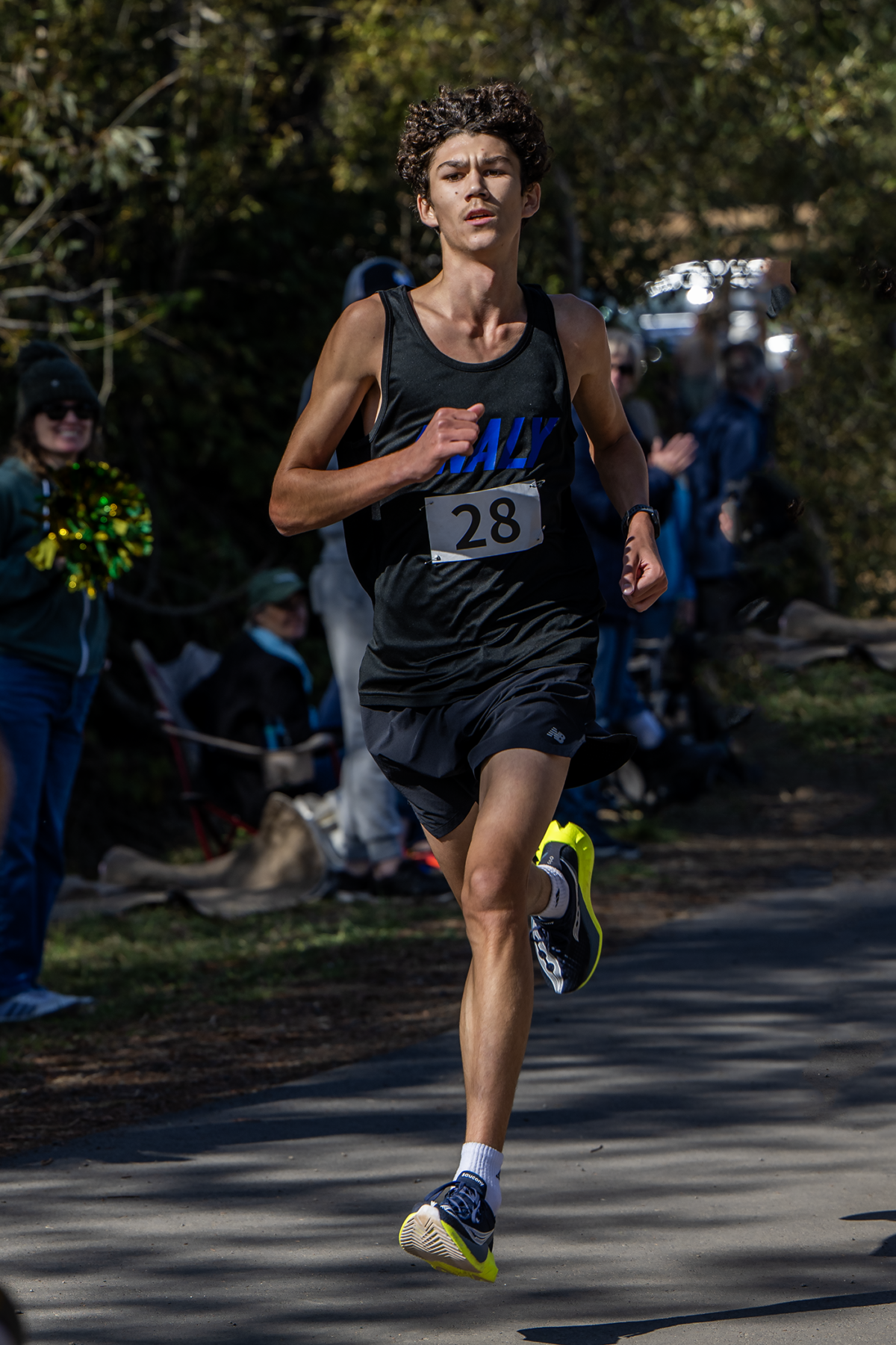 Runner sprinting in outdoor race wearing bib 28
