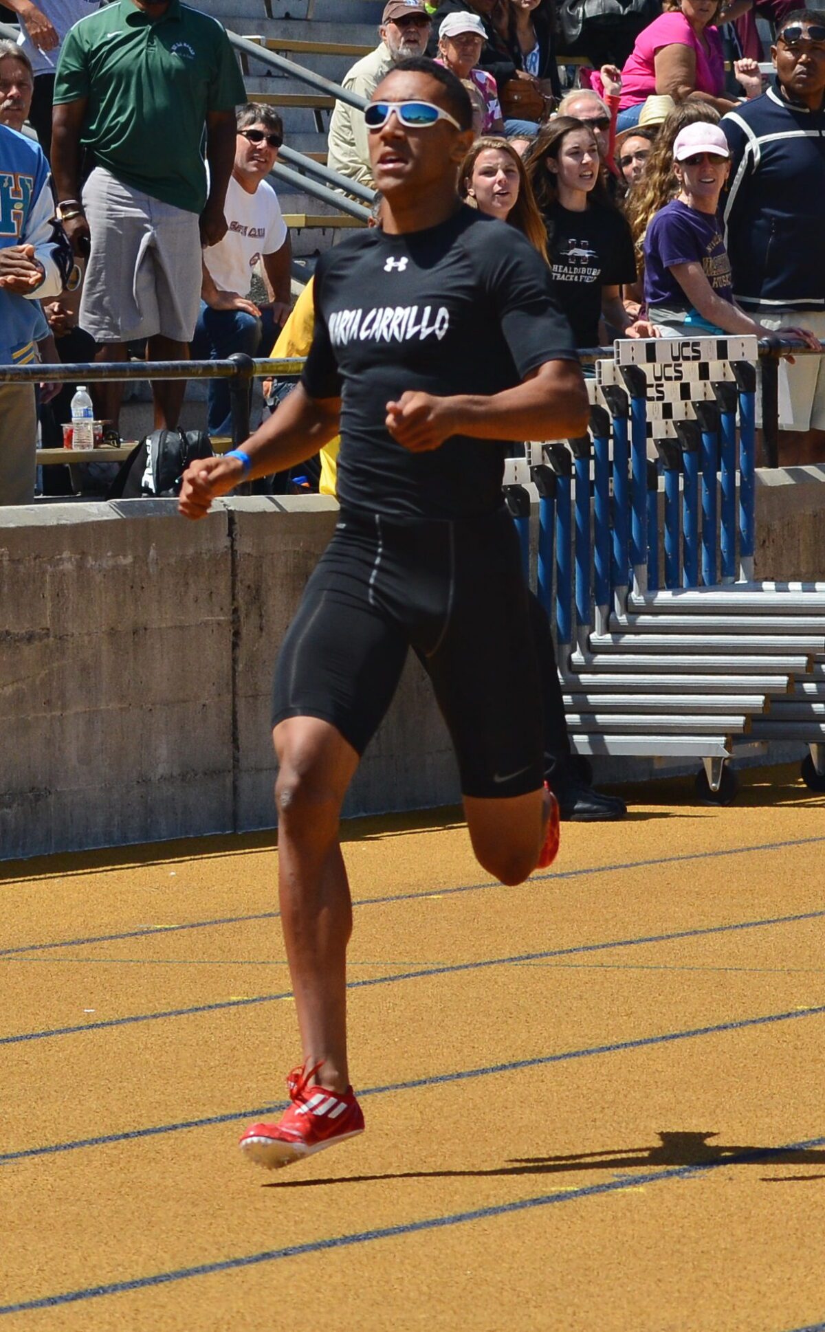 Runner airborne in black with red spikes