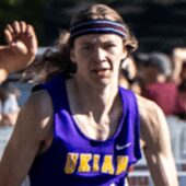 Long-haired racer in headband, purple Ukiah jersey