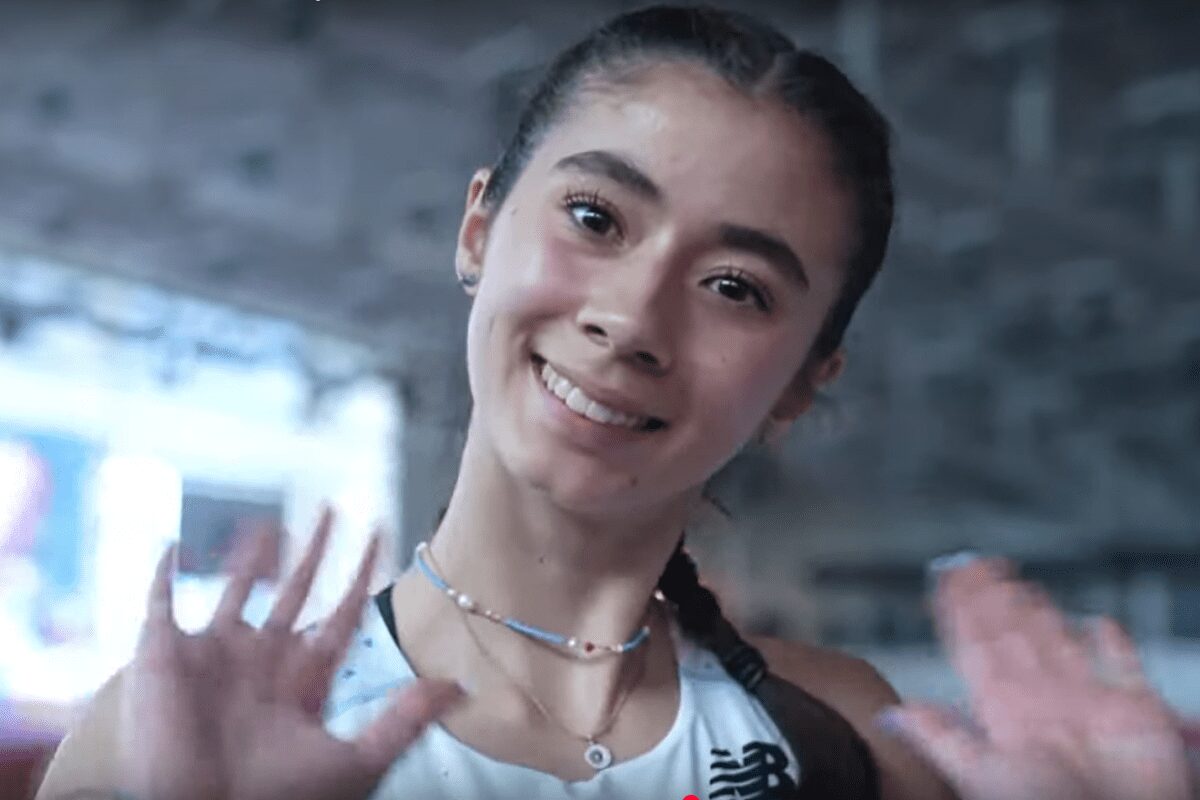 Smiling athlete waving at camera close-up