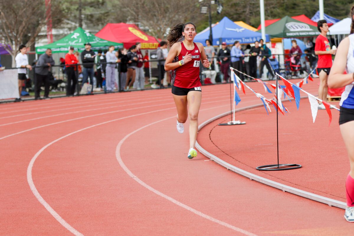 Solo runner rounding curve near colorful flags