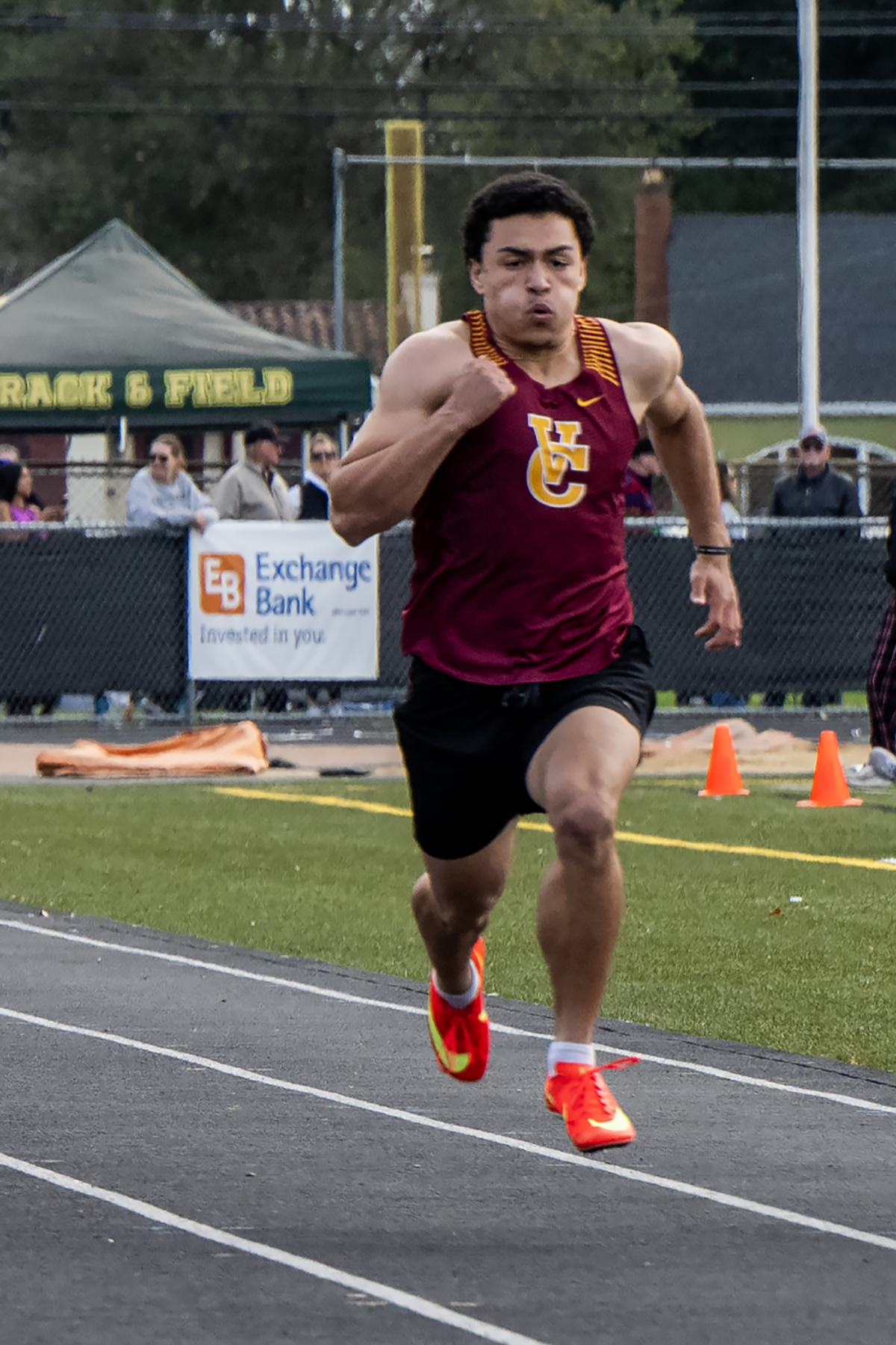 Sprinter powering forward in neon orange spikes